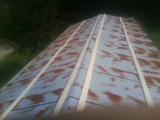 Rusted metal roof panels with new wood purlins before replacement — Storm Damage Roof Repair in Galena by Roofing Brothers